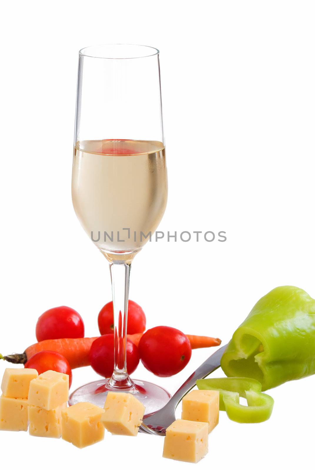 Glass of white wine with various types of cheese and garnishes on a white background