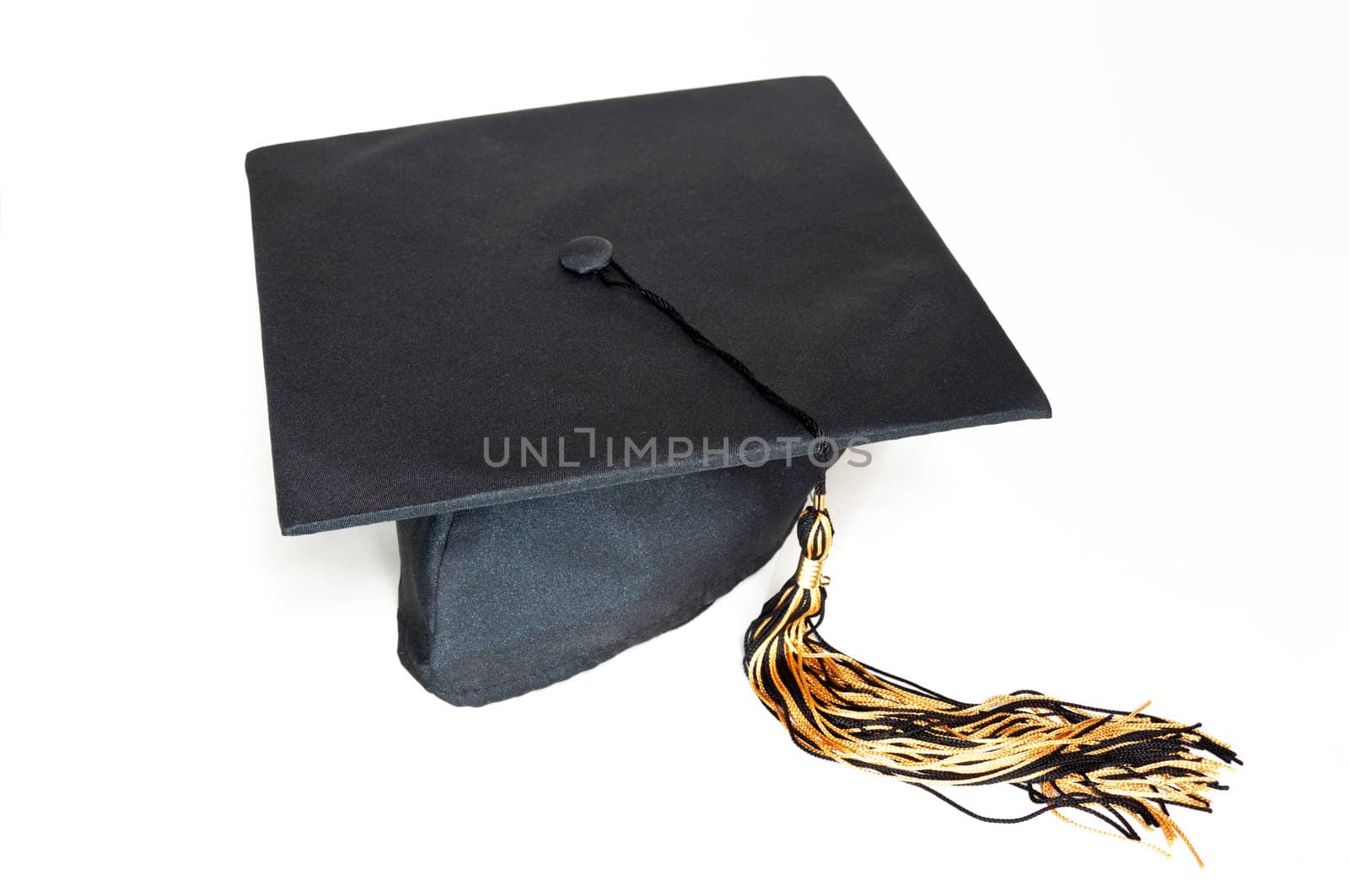 Black graduation cap with tassel on the white background.