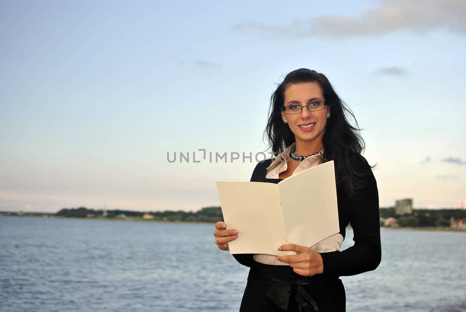 girl holding blank paper. sea on the background