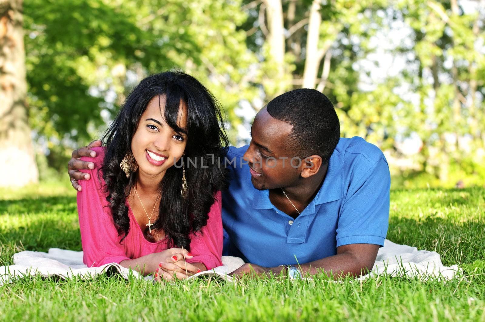 Young romantic couple enjoying summer day in park