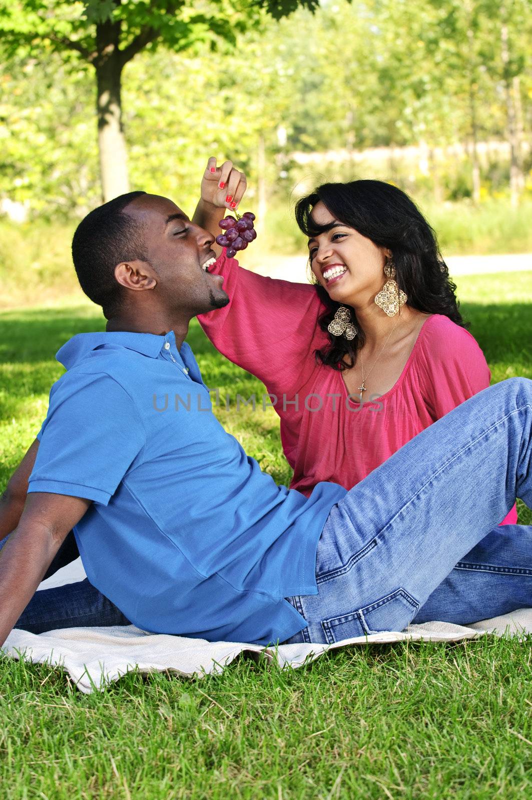 Young romantic couple having picnic in summer park