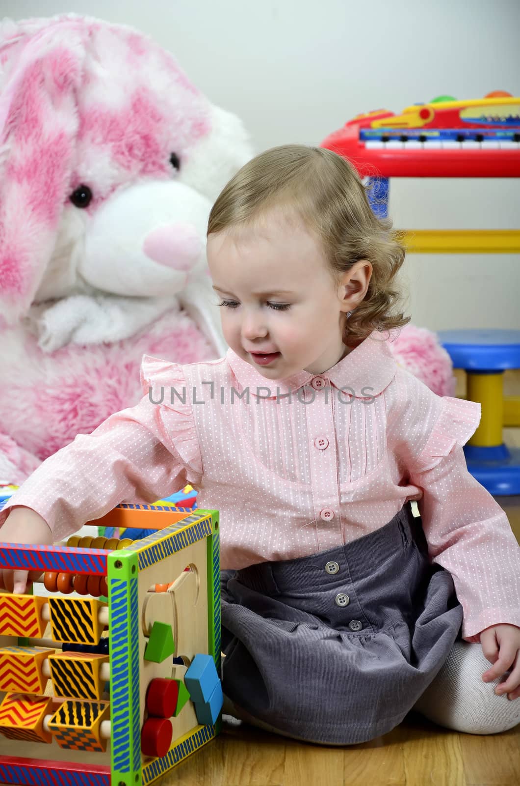 little girl in a room with toys