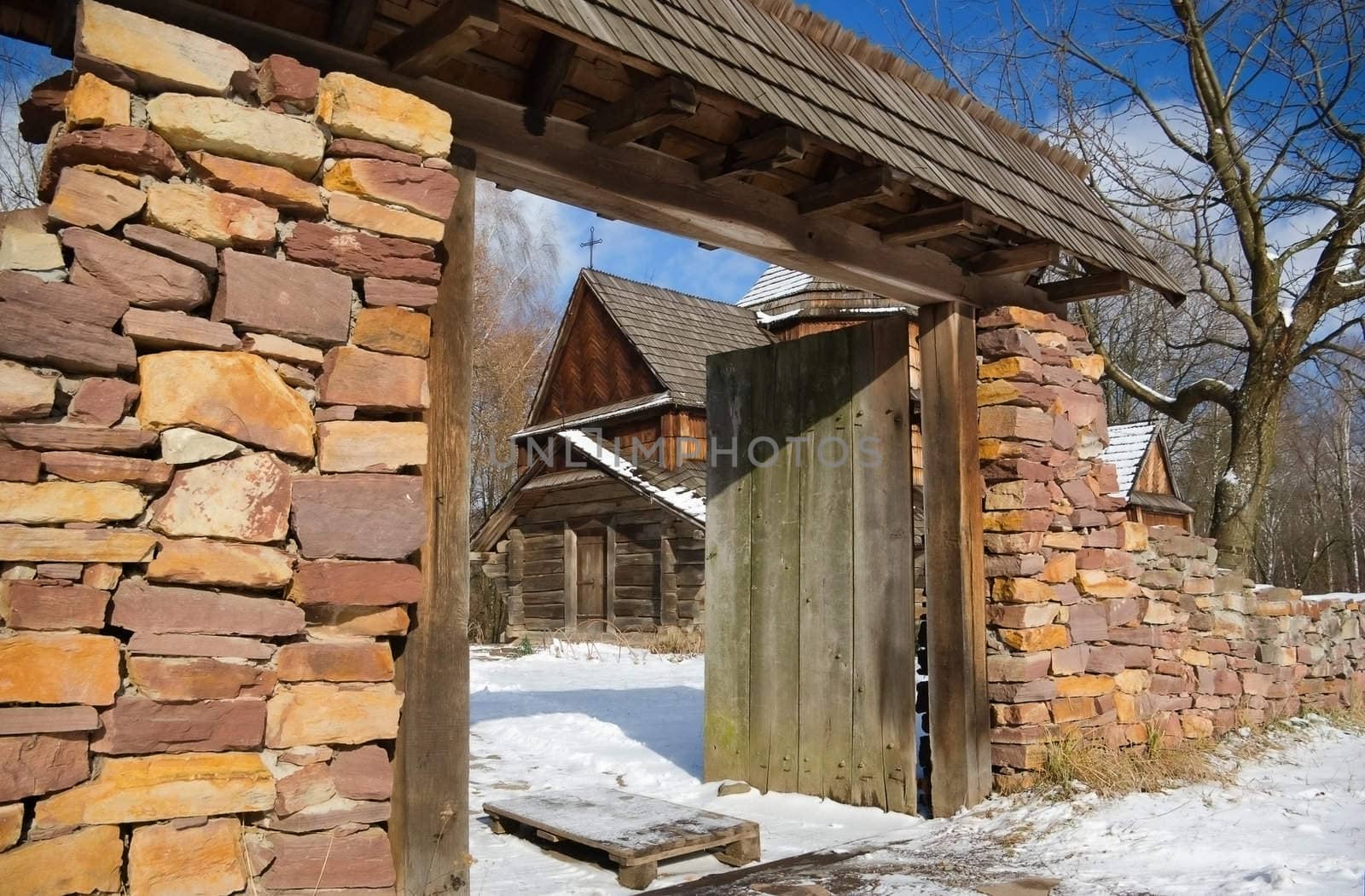 old stone fence with a gate built of granite

