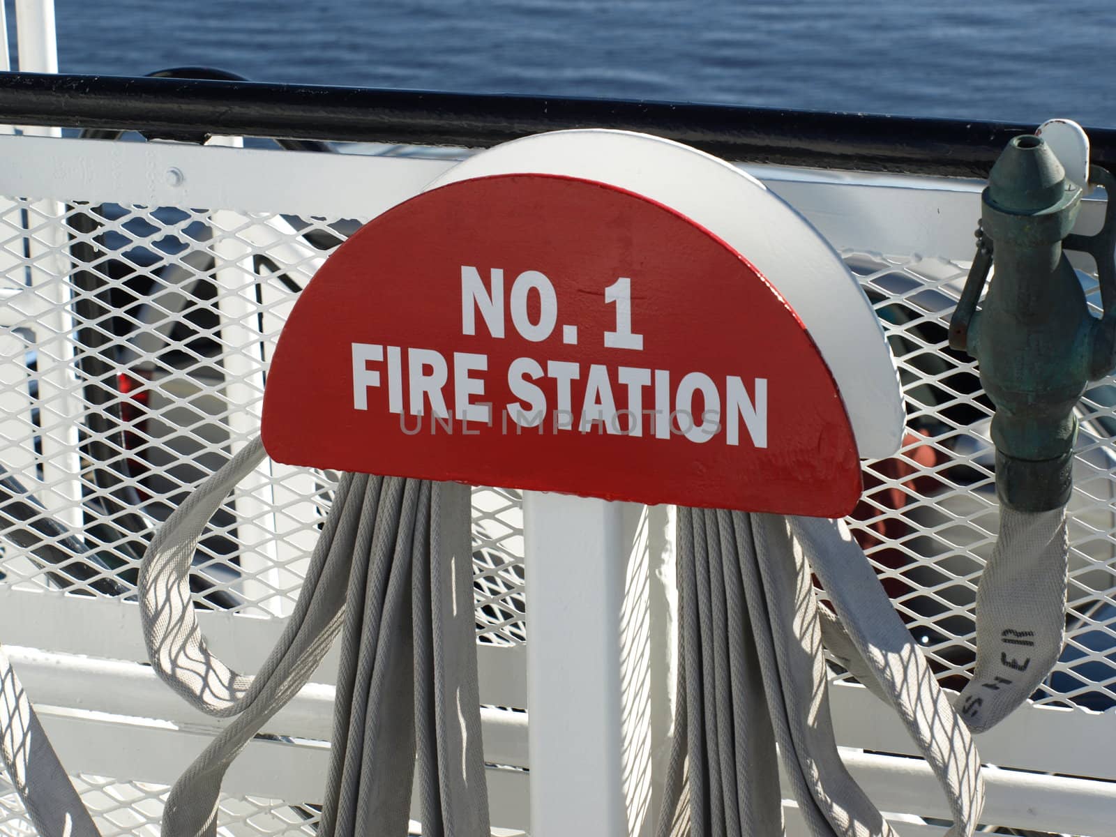 A fire station sign on a ferry crossing the water
