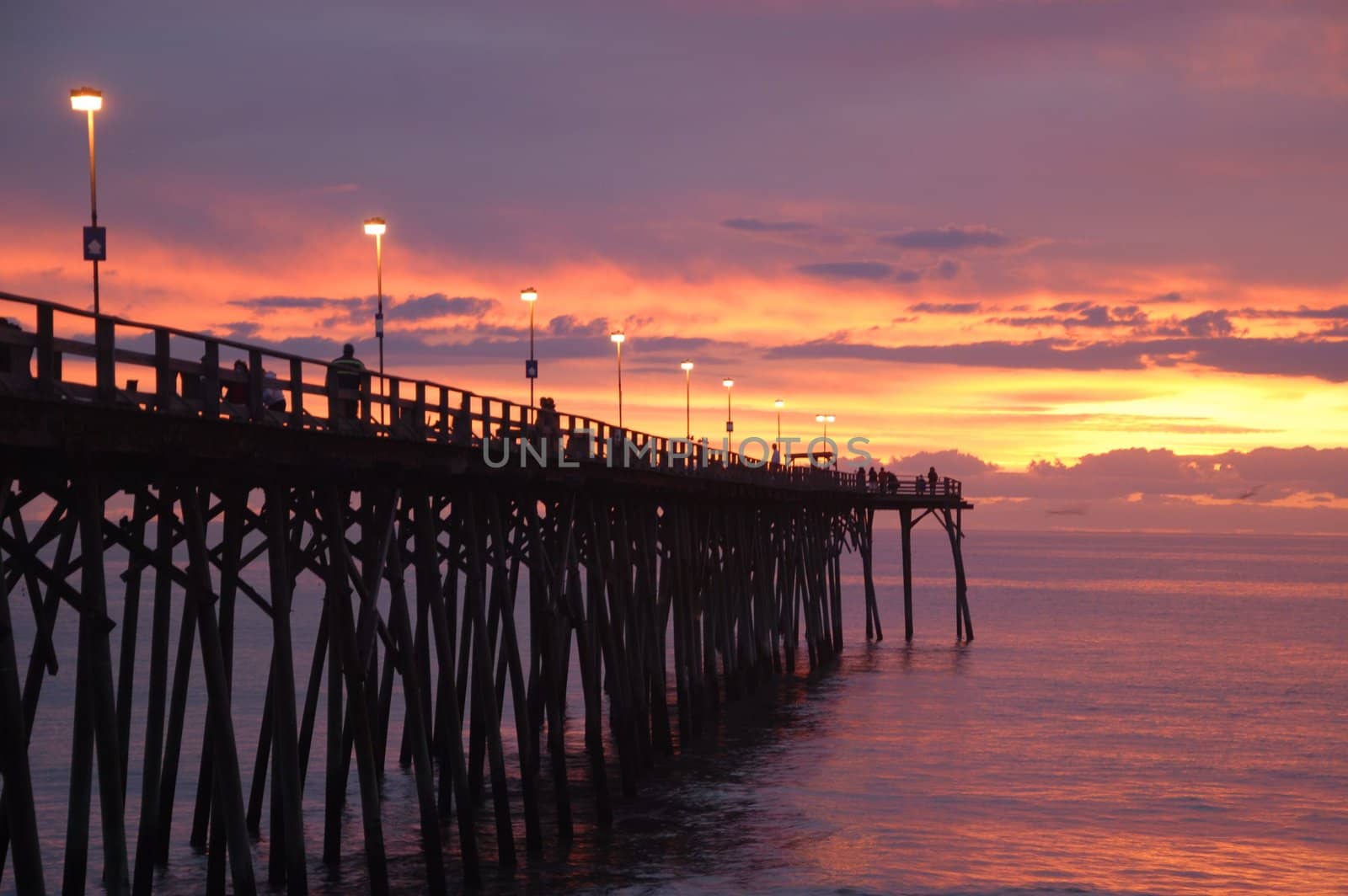 The sunrise over the pier at Kure Beach. 