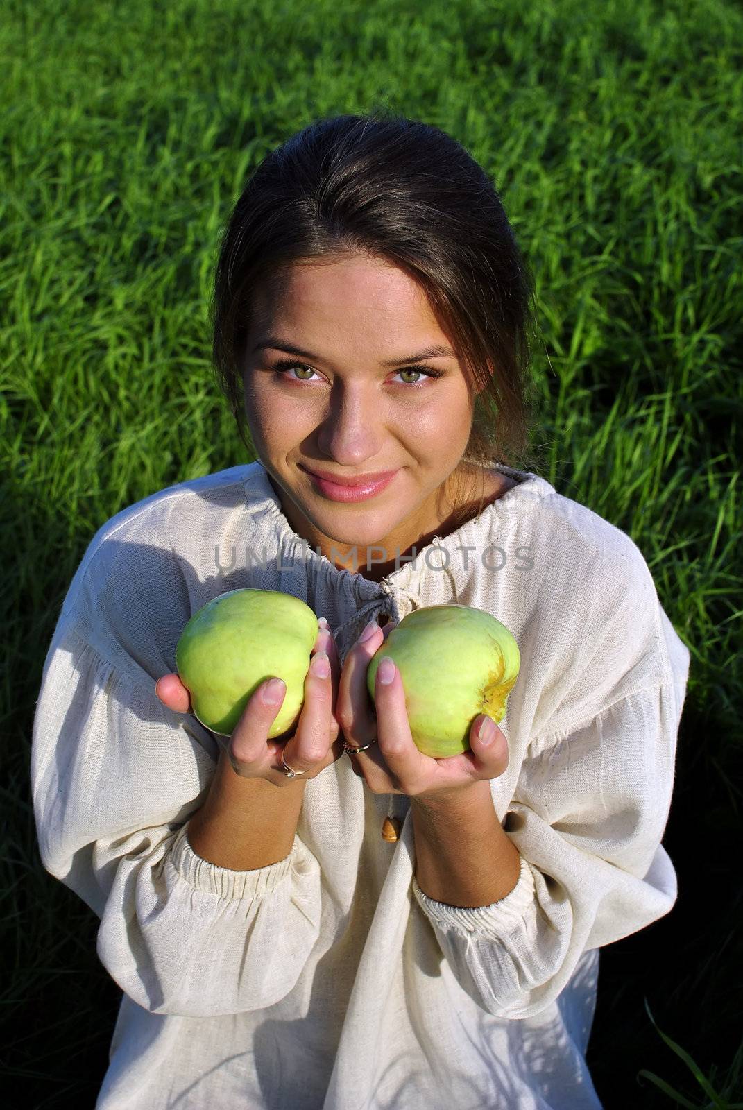 girl in a linen shirt, holding apples