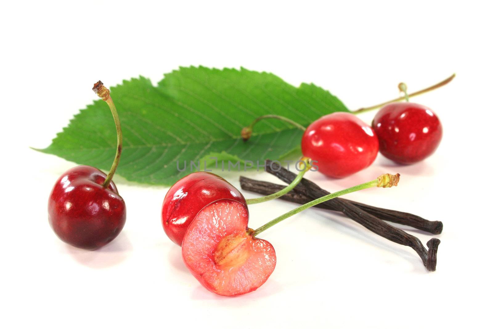 fresh cherries with vanilla on white background