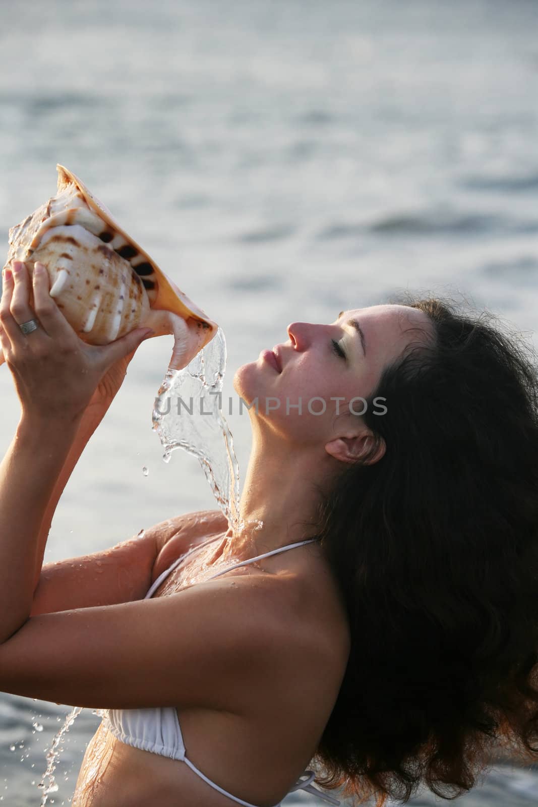 The beautiful girl with a cockleshell. Bali. Indonesia