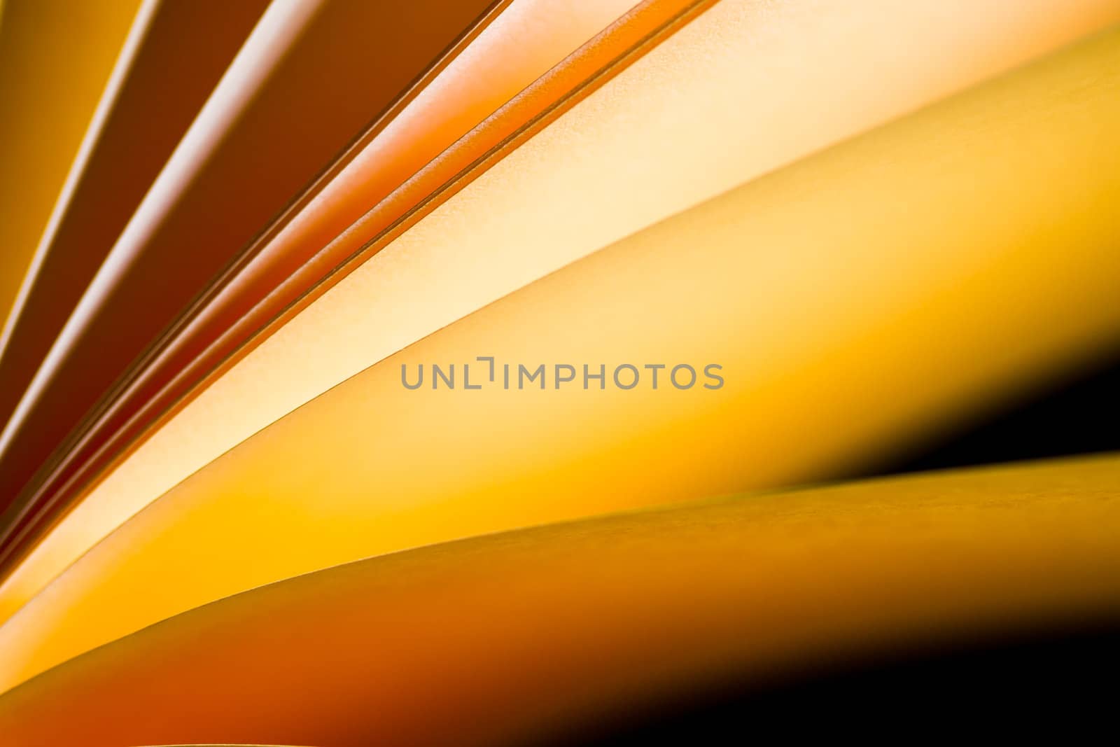 yellowish brown notepad paper illuminated by LED lights in landscape orientation with paper from bottom left frame