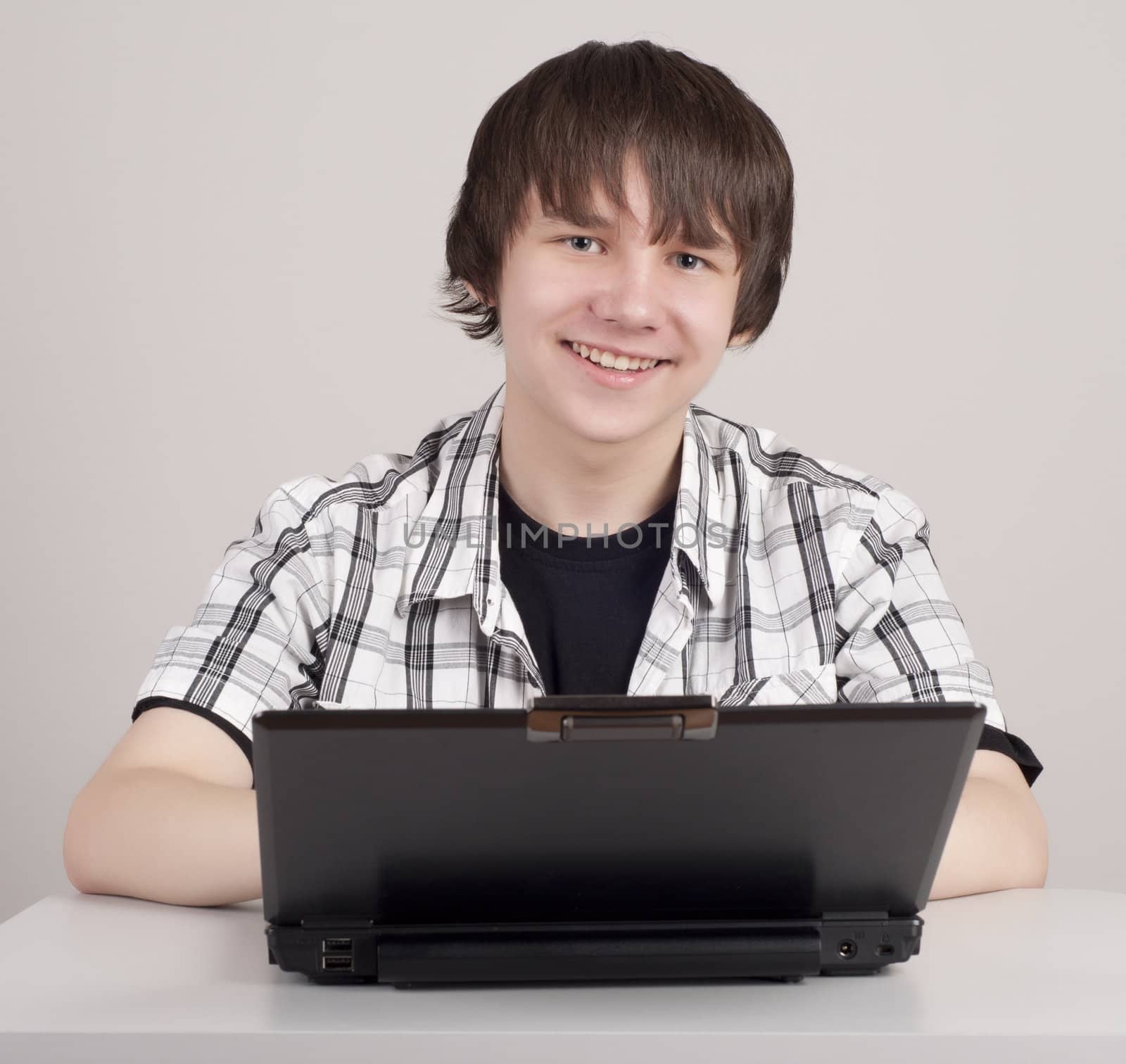 student sits for a portable computer by adam121