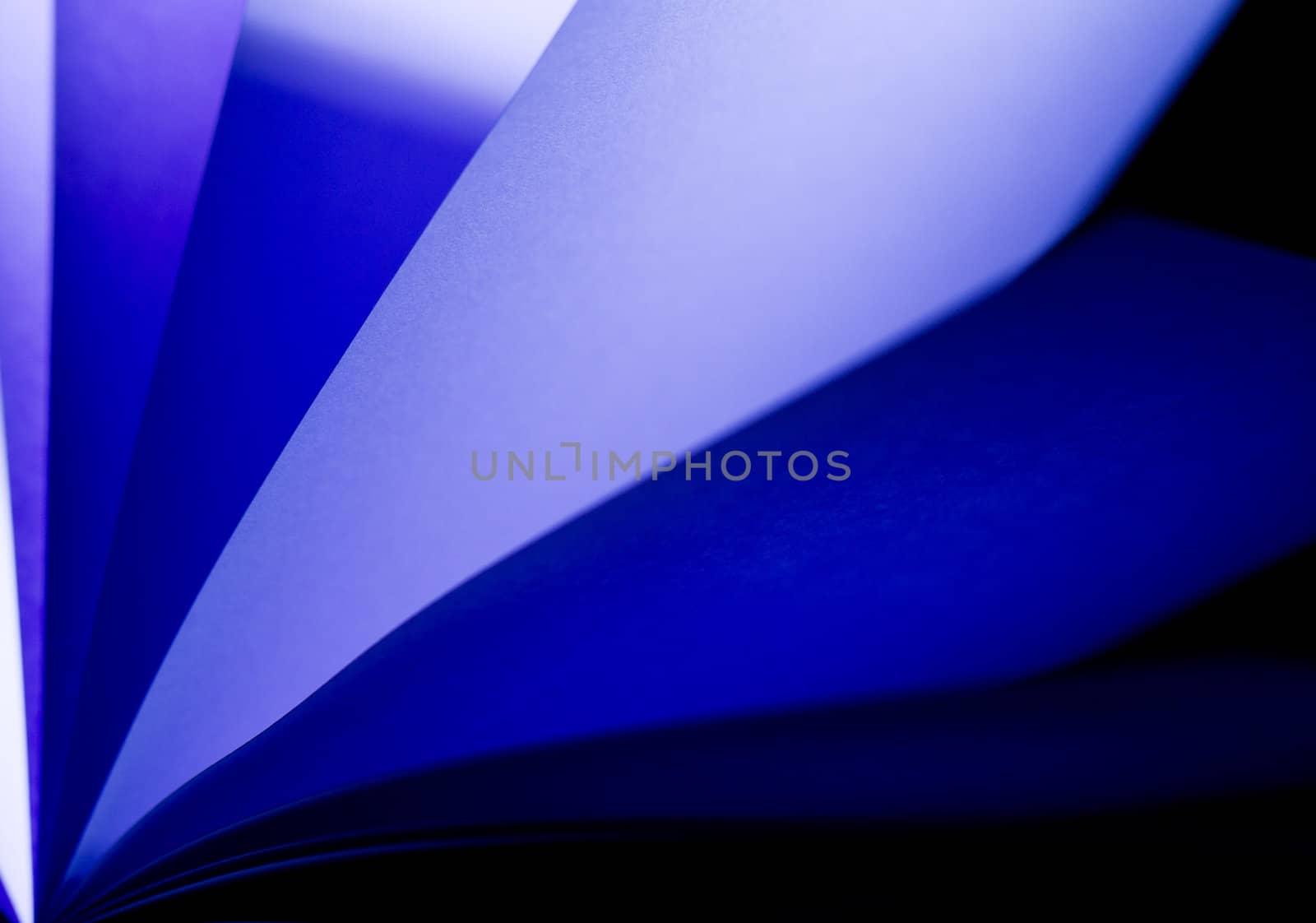 blue notepad paper illuminated by LED lights from lower left in landscape orientation