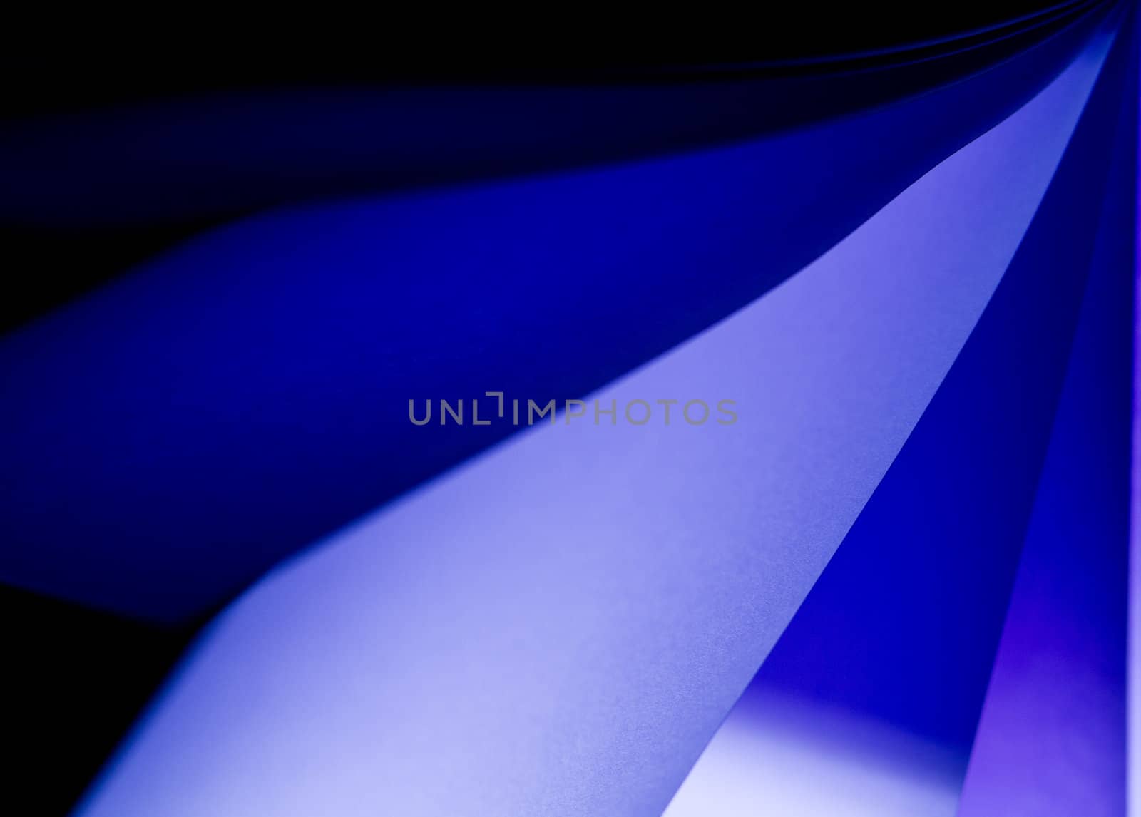 blue notepad paper illuminated by LED lights from upper right in landscape orientation