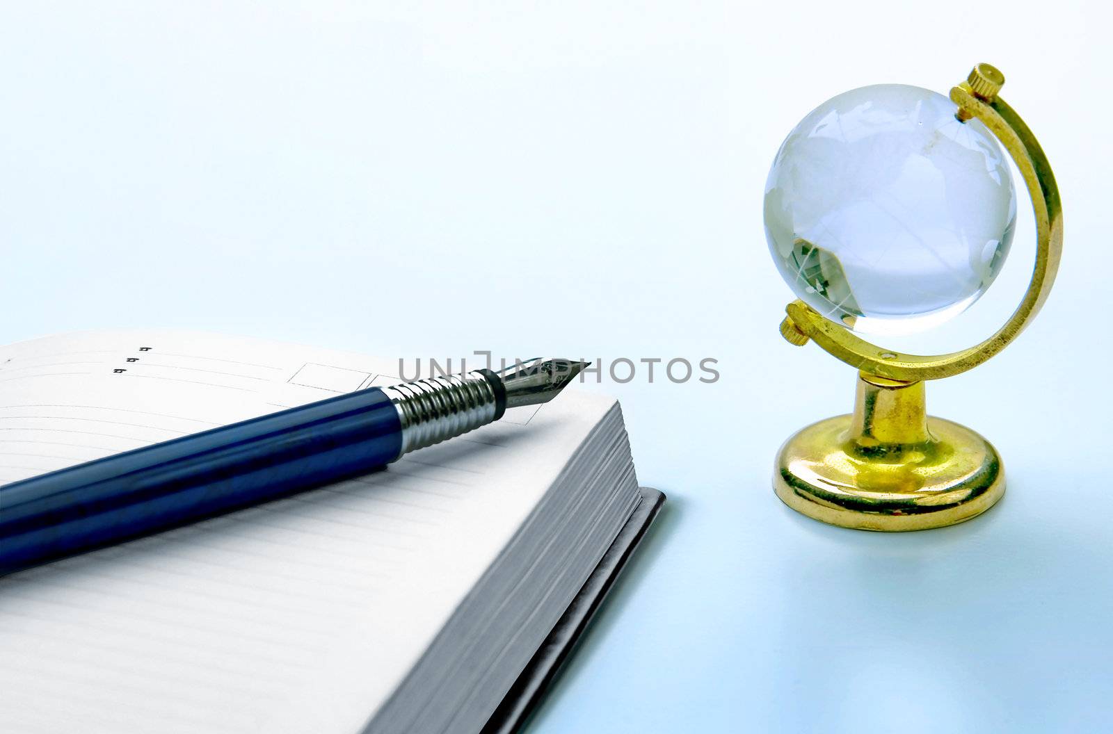 notebook and pen, globe