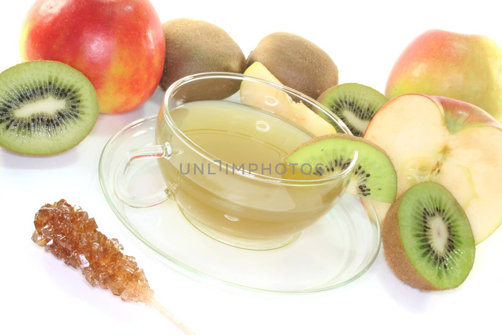 a glass of Kiwi and apple tea with fresh kiwis and apples