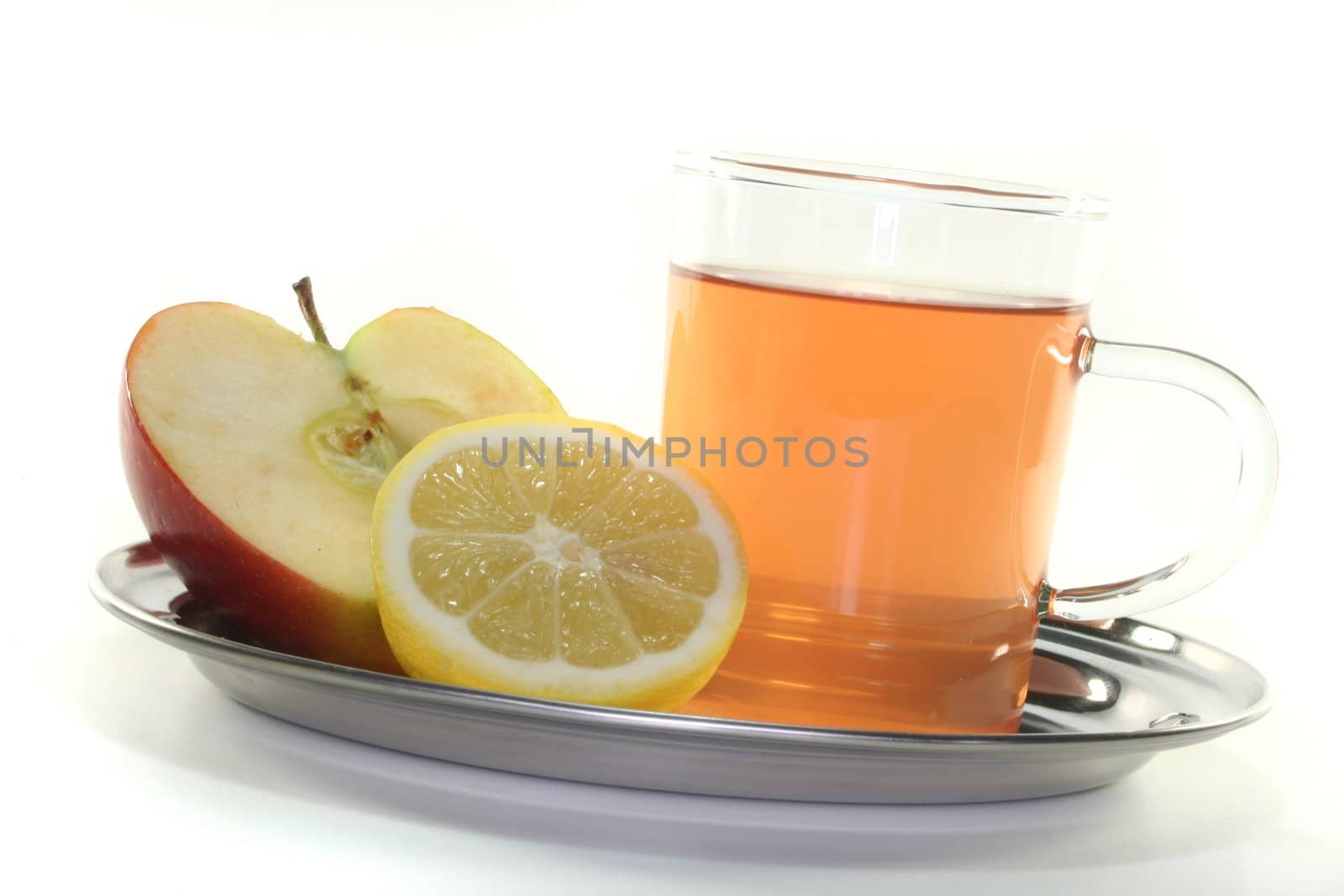 a glass of apple-lemon tea with fresh apple and lemon