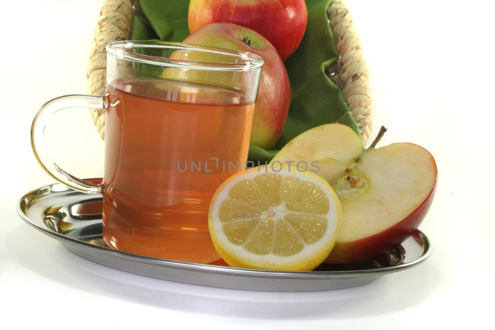 a glass of apple-lemon tea with fresh apple and lemon