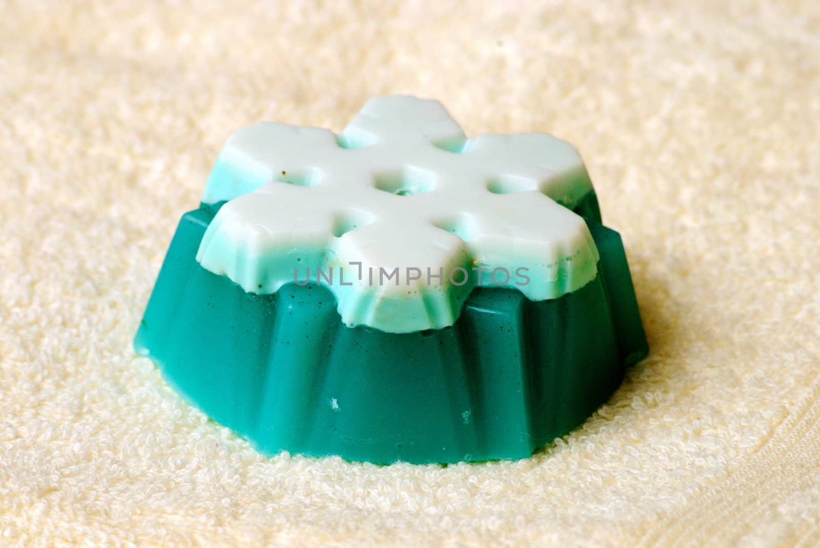 Natural Handmade Snowflake-Shaped Soap on a white towel.