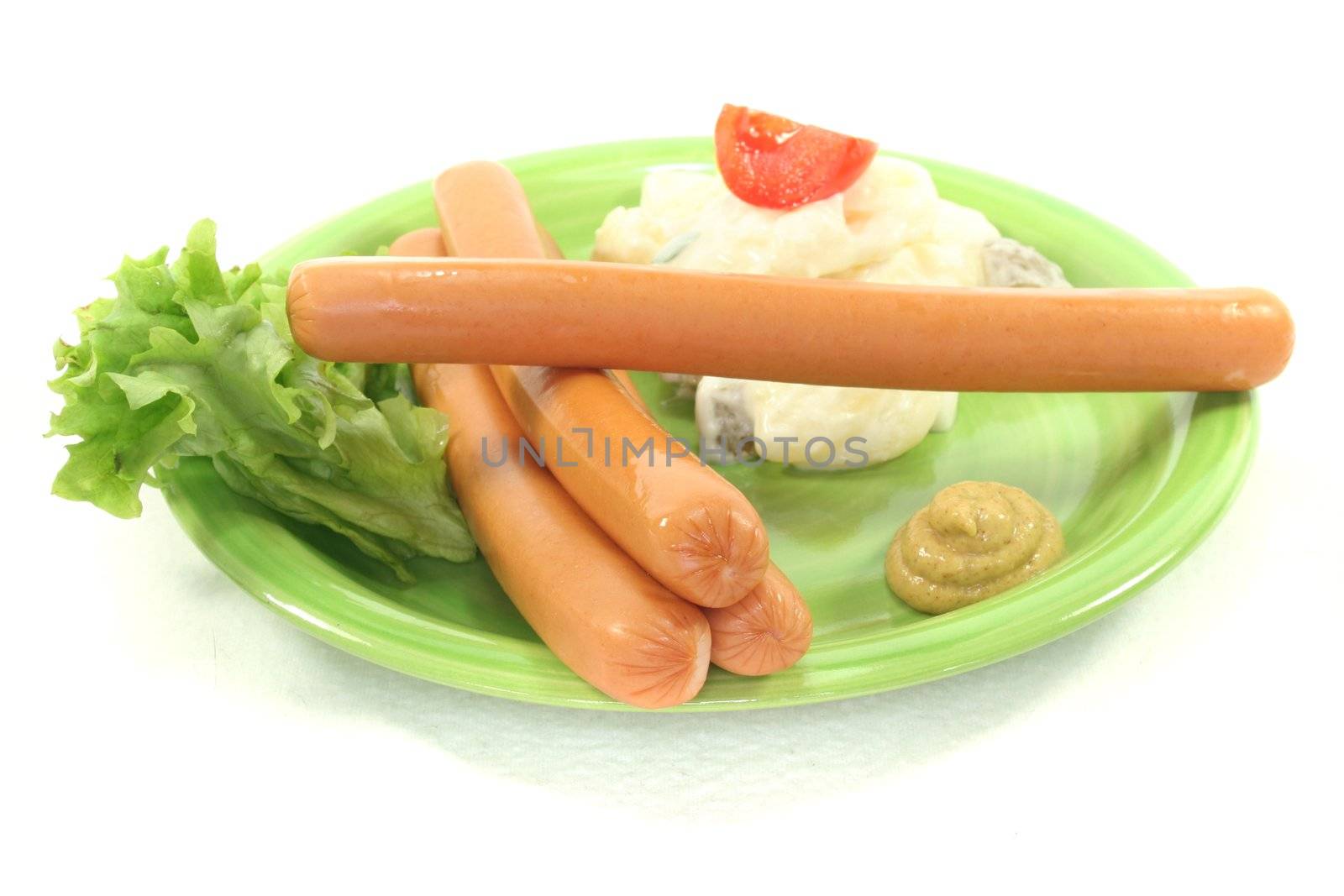 Wiener Sausage with potato salad and lettuce on a white background