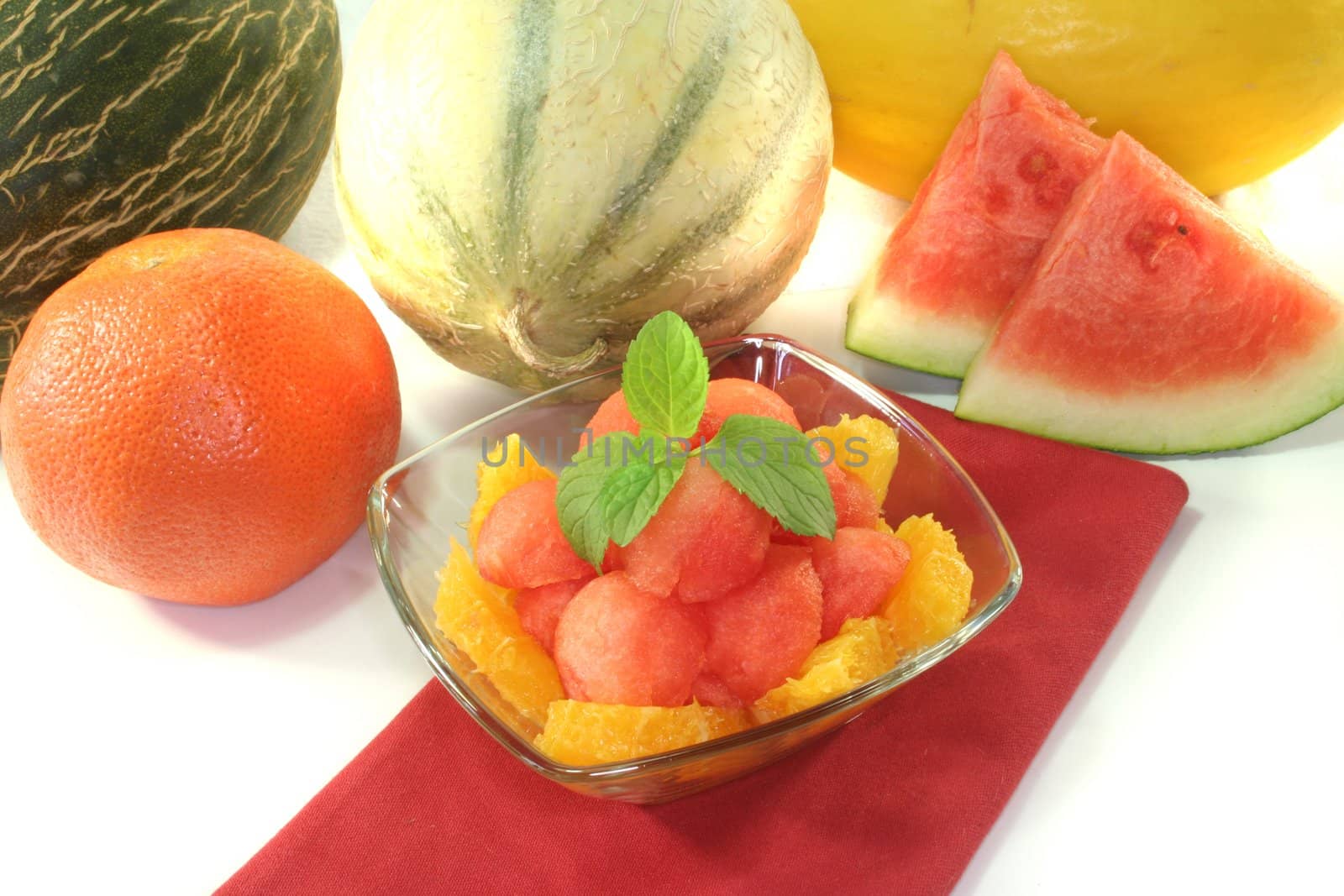 Melon orange salad with fresh peppermint in a bowl