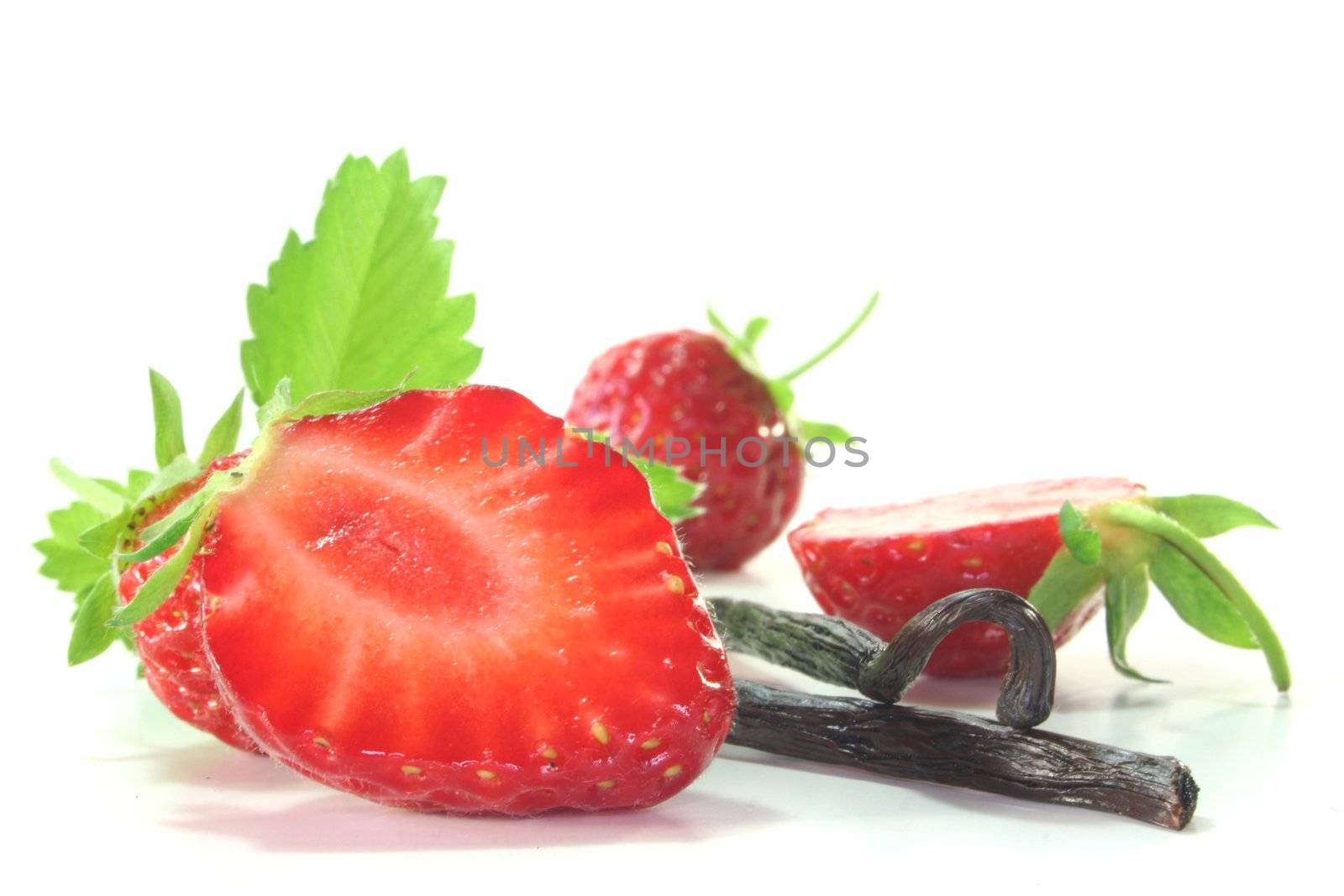 fresh half strawberries with vanilla on a white background