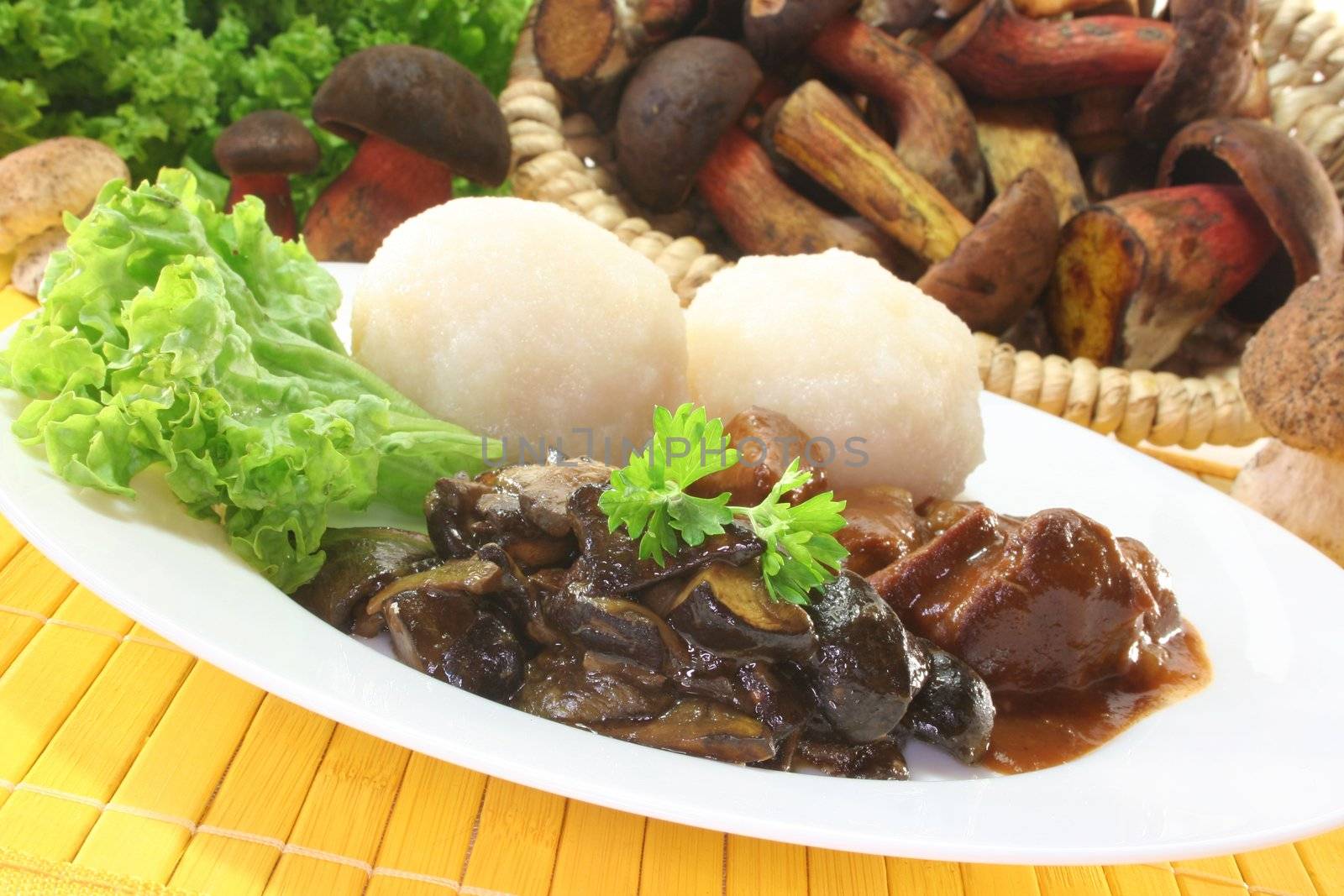 Game goulash with dumplings and fresh mushrooms