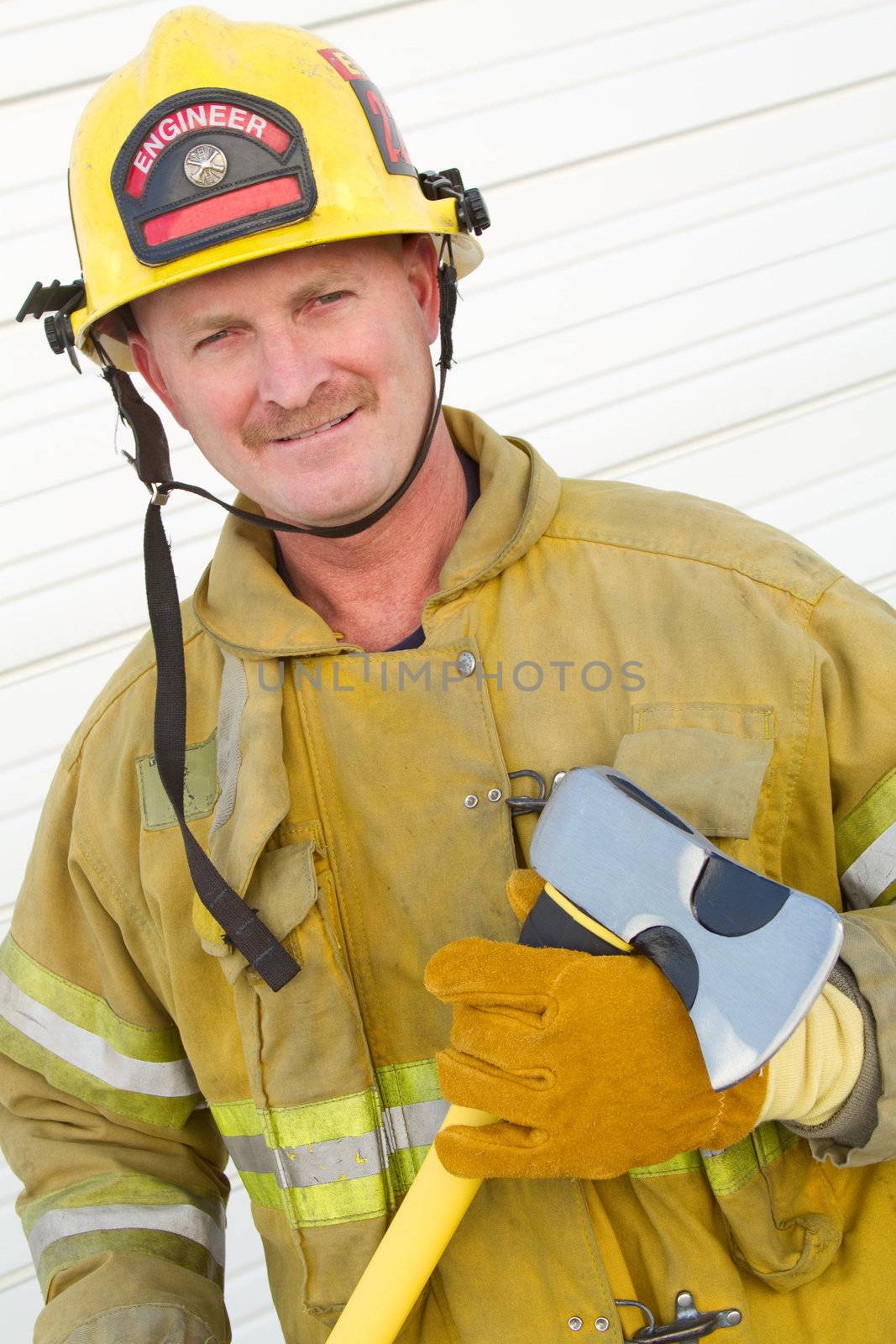Smiling firefighter man holding axe