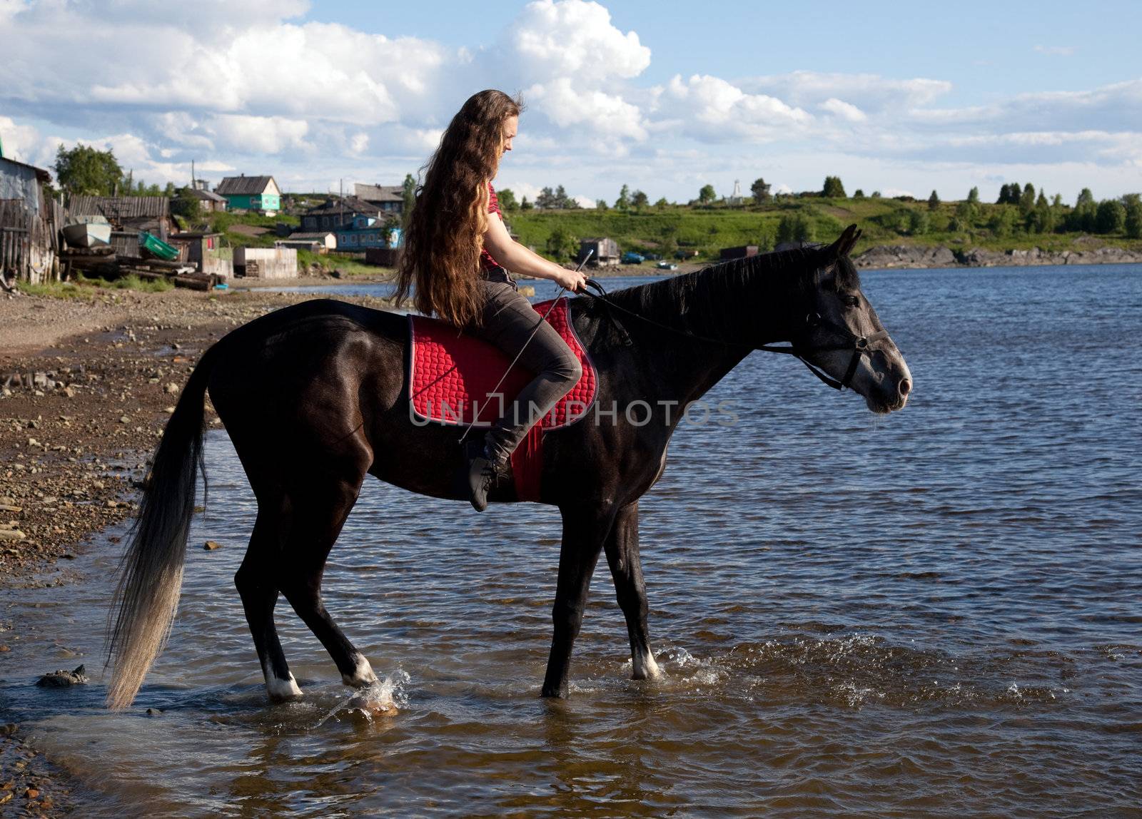 A girl with flowing hair on a black horse by AleksandrN