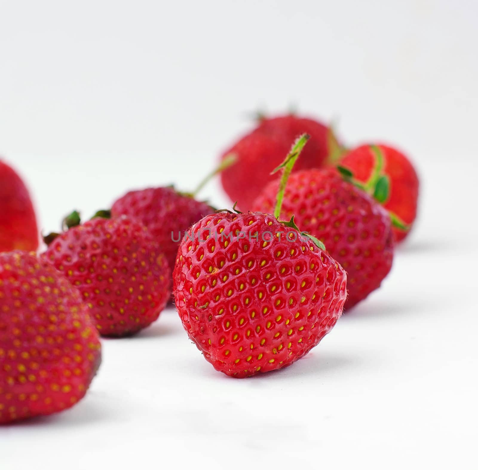 Strawberries Composition. Few ripe strawberries on a white background