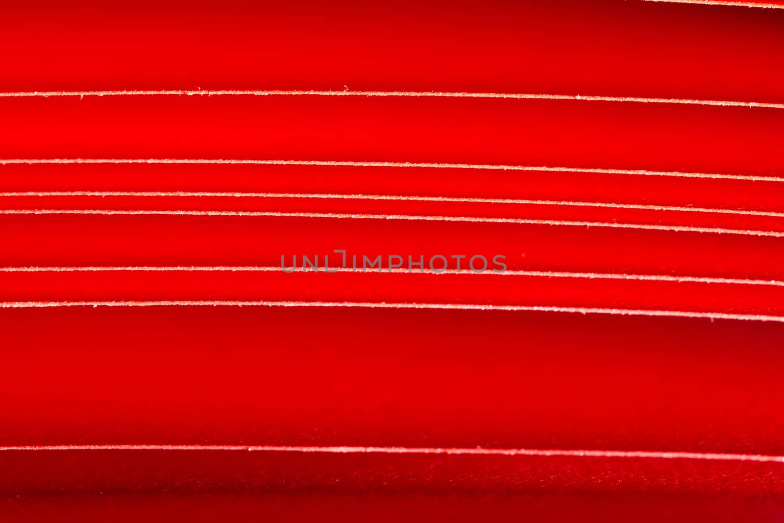 the edges of red A4 paper seen as lines with red background when the paper is under illumination