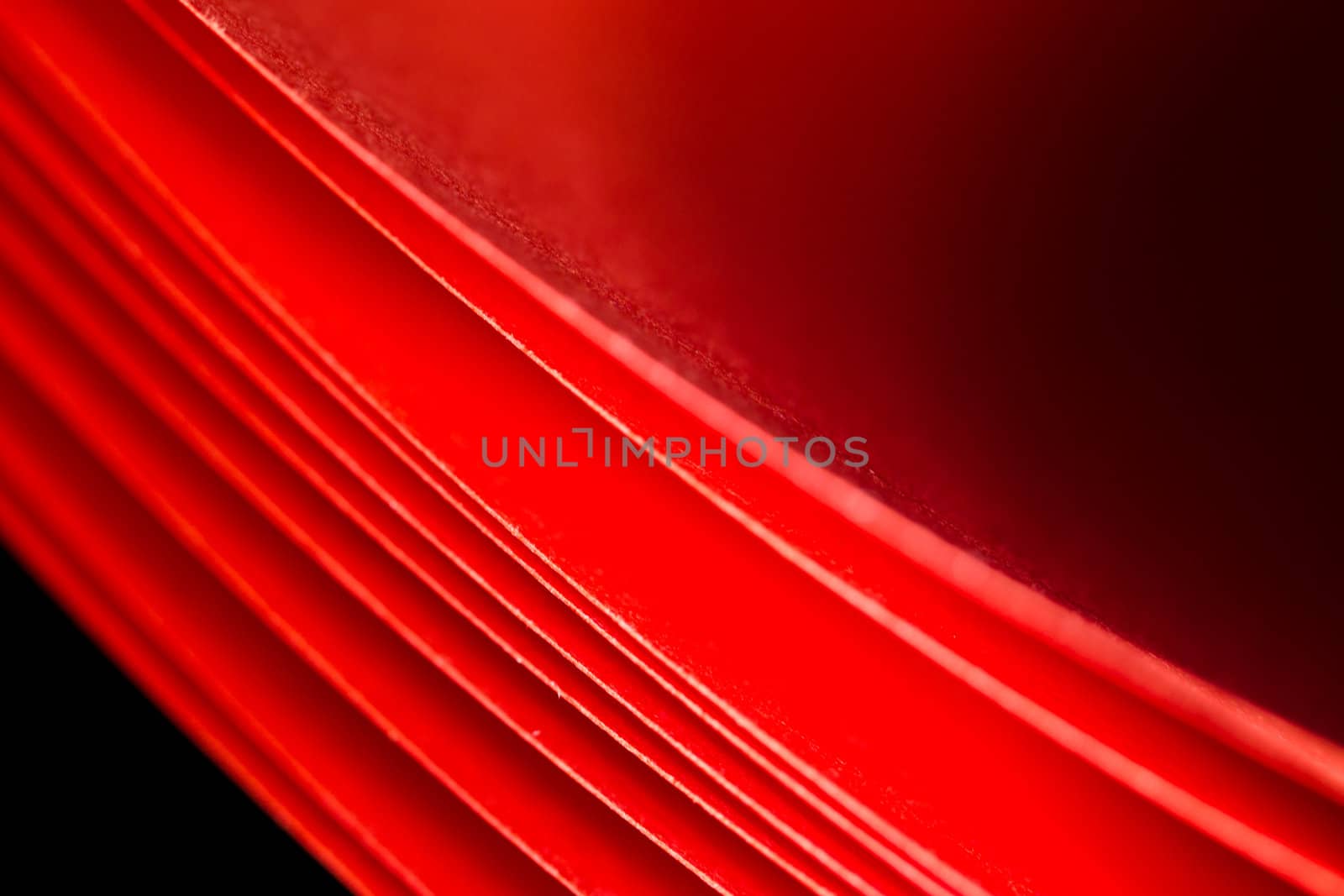the texture of red A4 paper illuminated with LED lights in black background