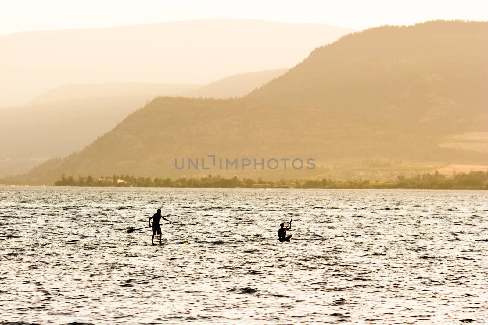 two silhouettes on water