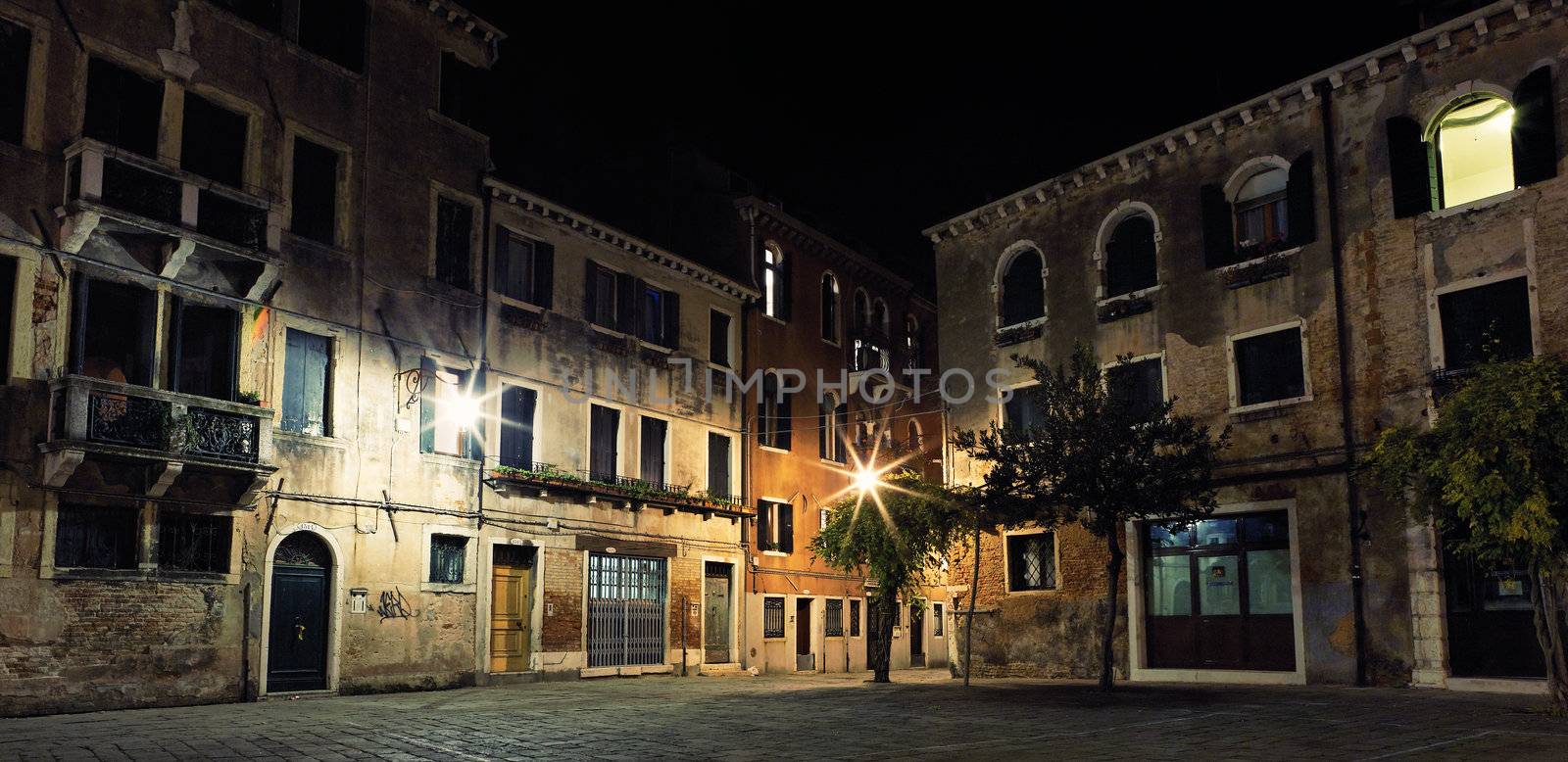 Little place with paving stone in Venice by night