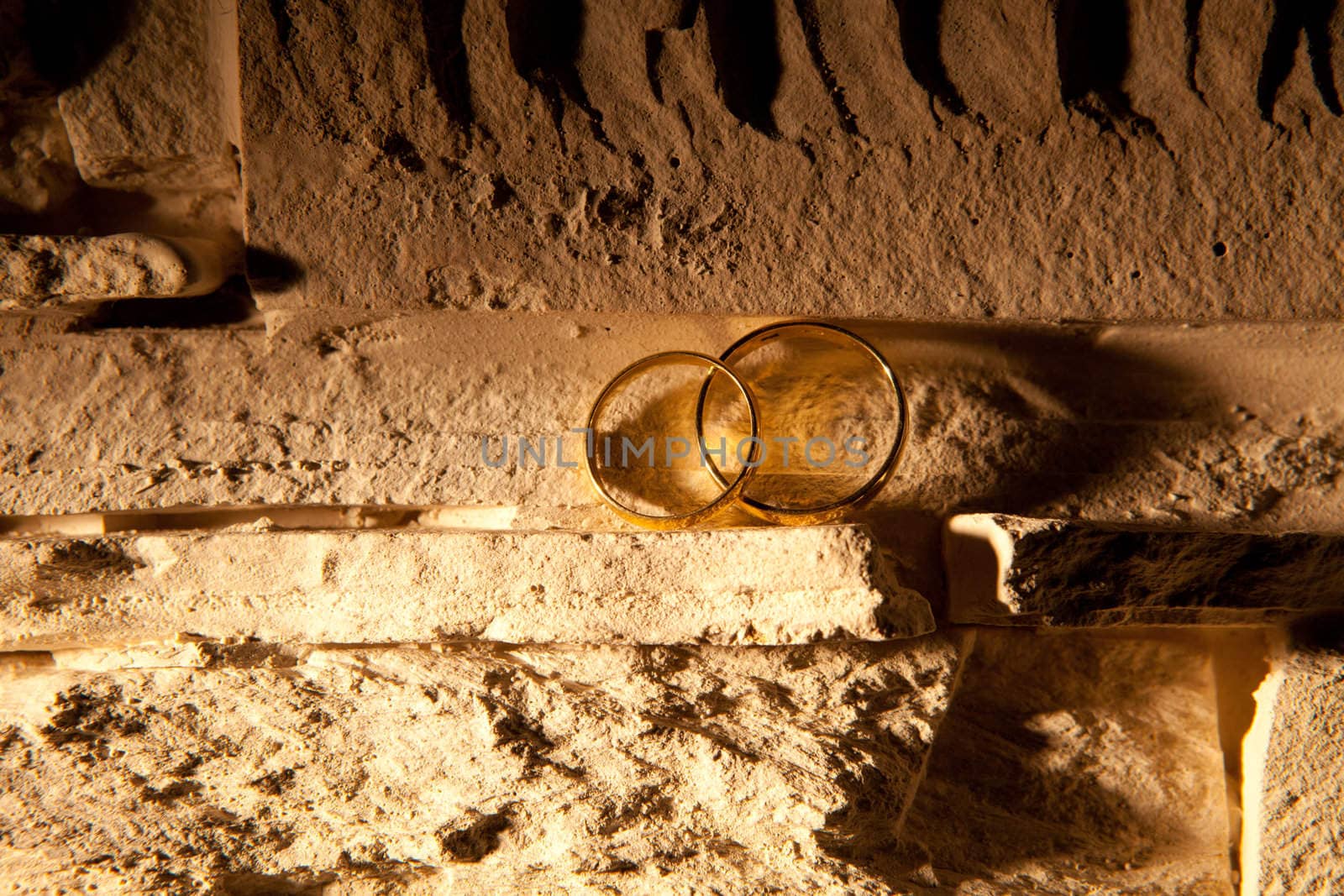 wedding rings on the stone wall