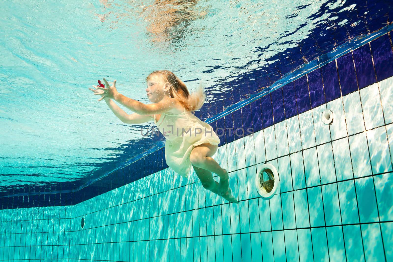 girl in the swimming-pool under water with a flower