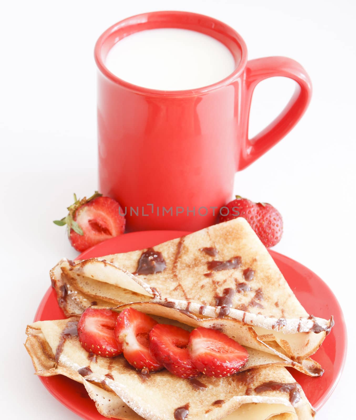 sweet meal with cup of milk and cakes and chocholate and strawberries