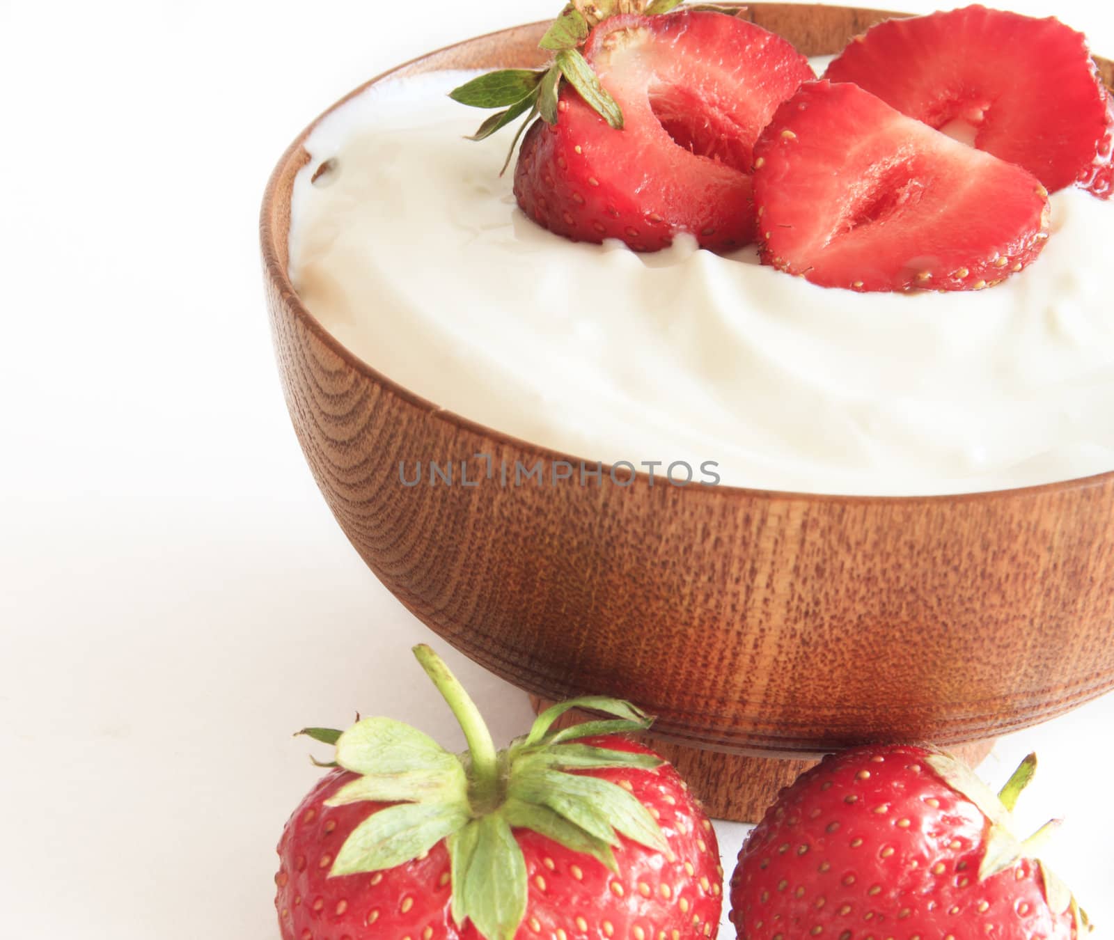 strawberry and yogurt  in a wooden bowl