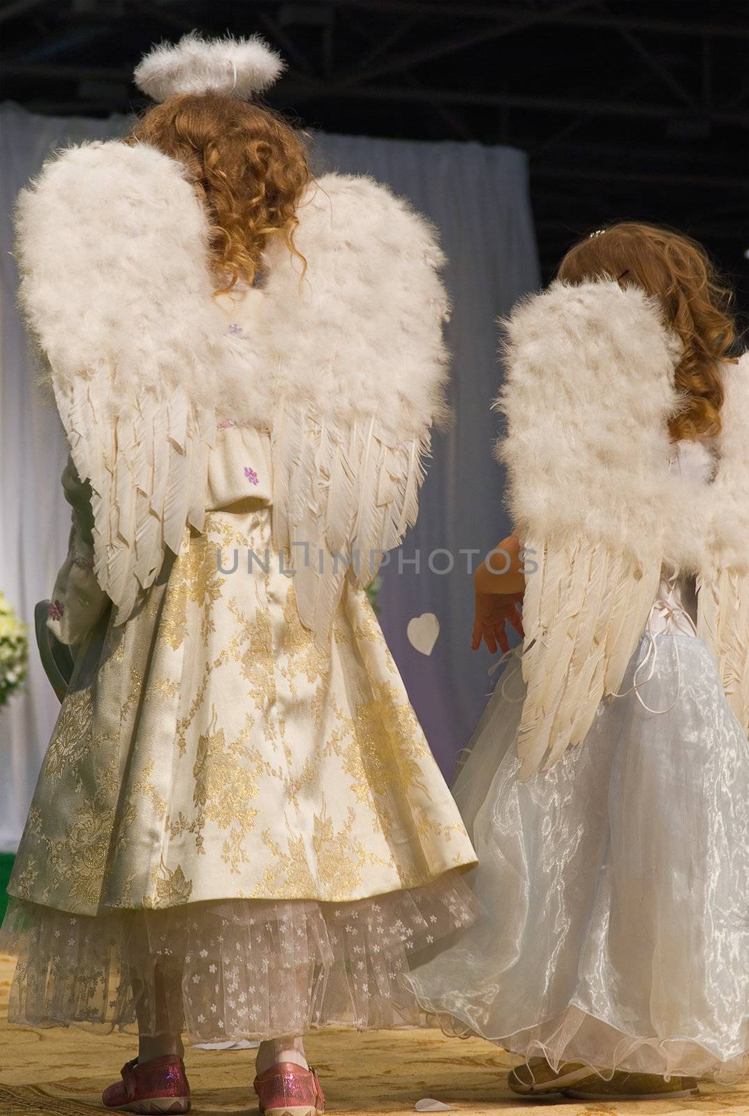 little girls in white dress and angel wings