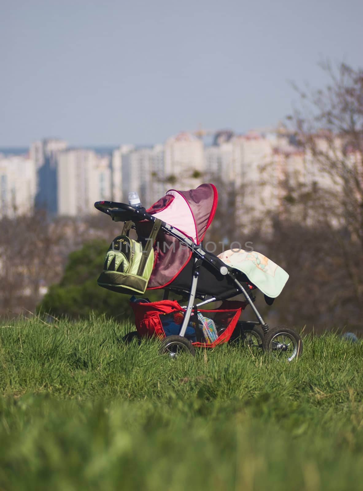  baby carriage sits alone on the grass