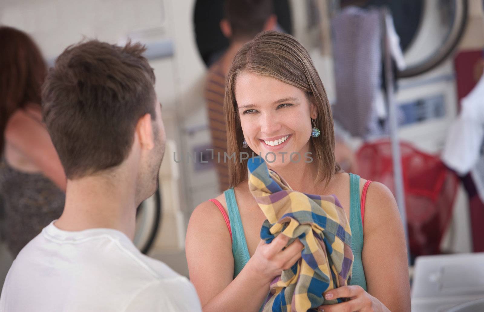 Beautiful smiling Caucasian woman holds a plaid shirt 
