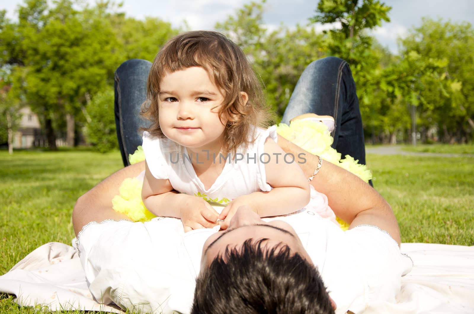 The father holds the cheerful daughter in his arms