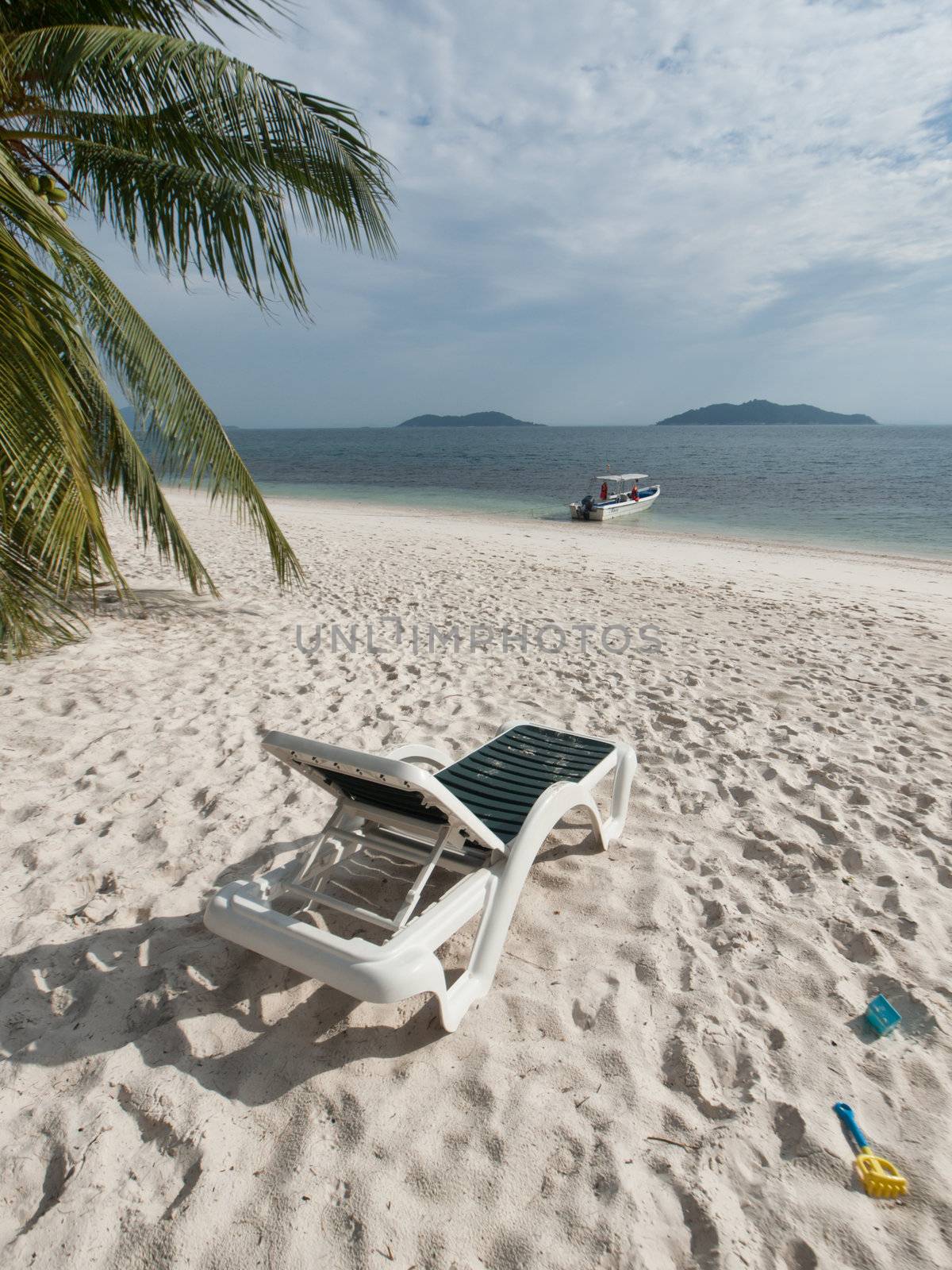 Paradise beach in Rawa island in Malaysia with relax chairs and beach toys
