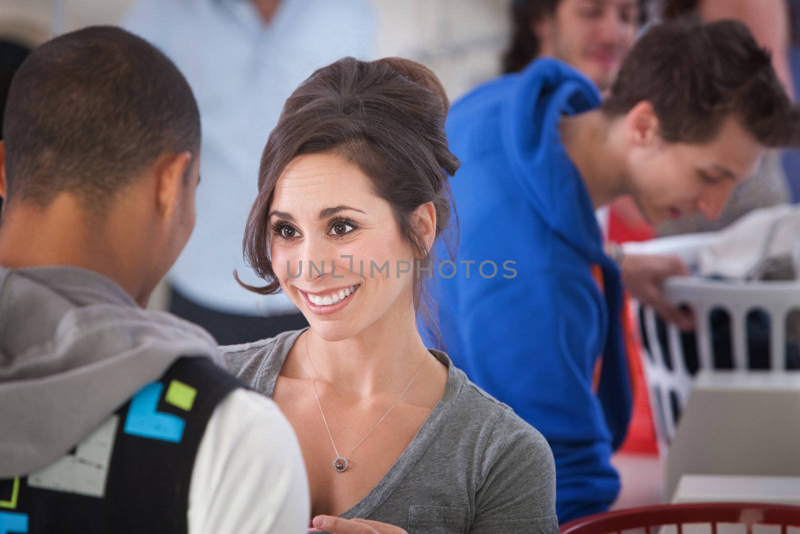 Beautiful Caucasian woman smiles at a guy in the laundromat