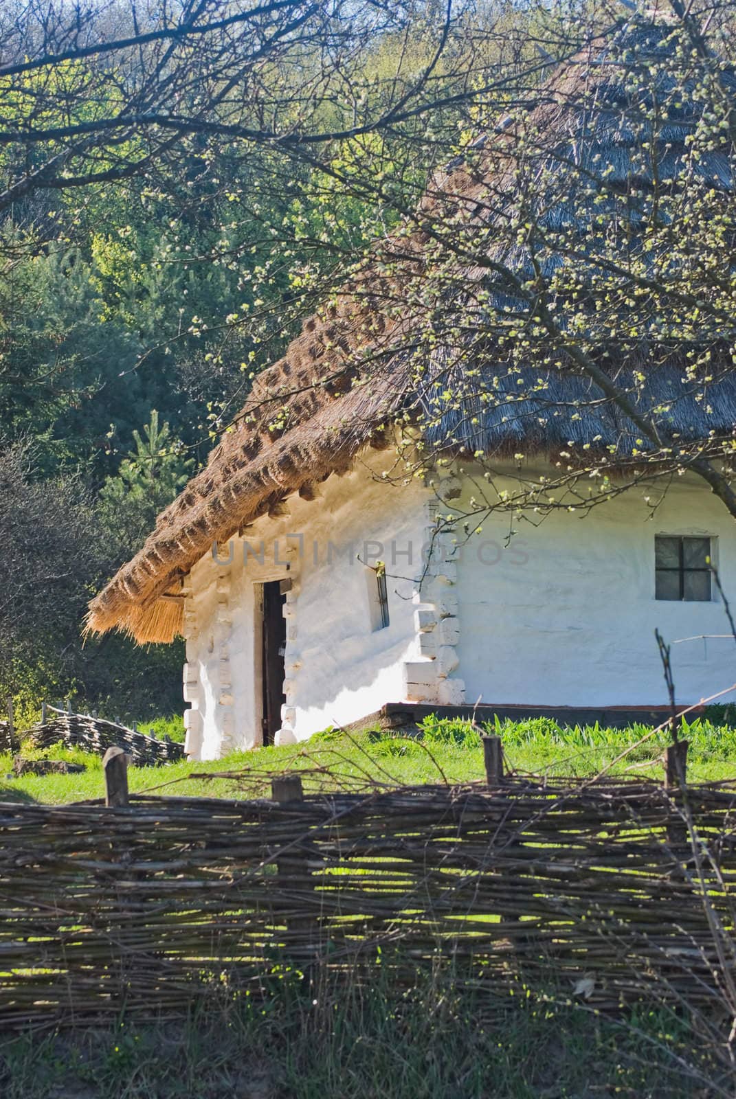 wicker fence against the backdrop of an old house