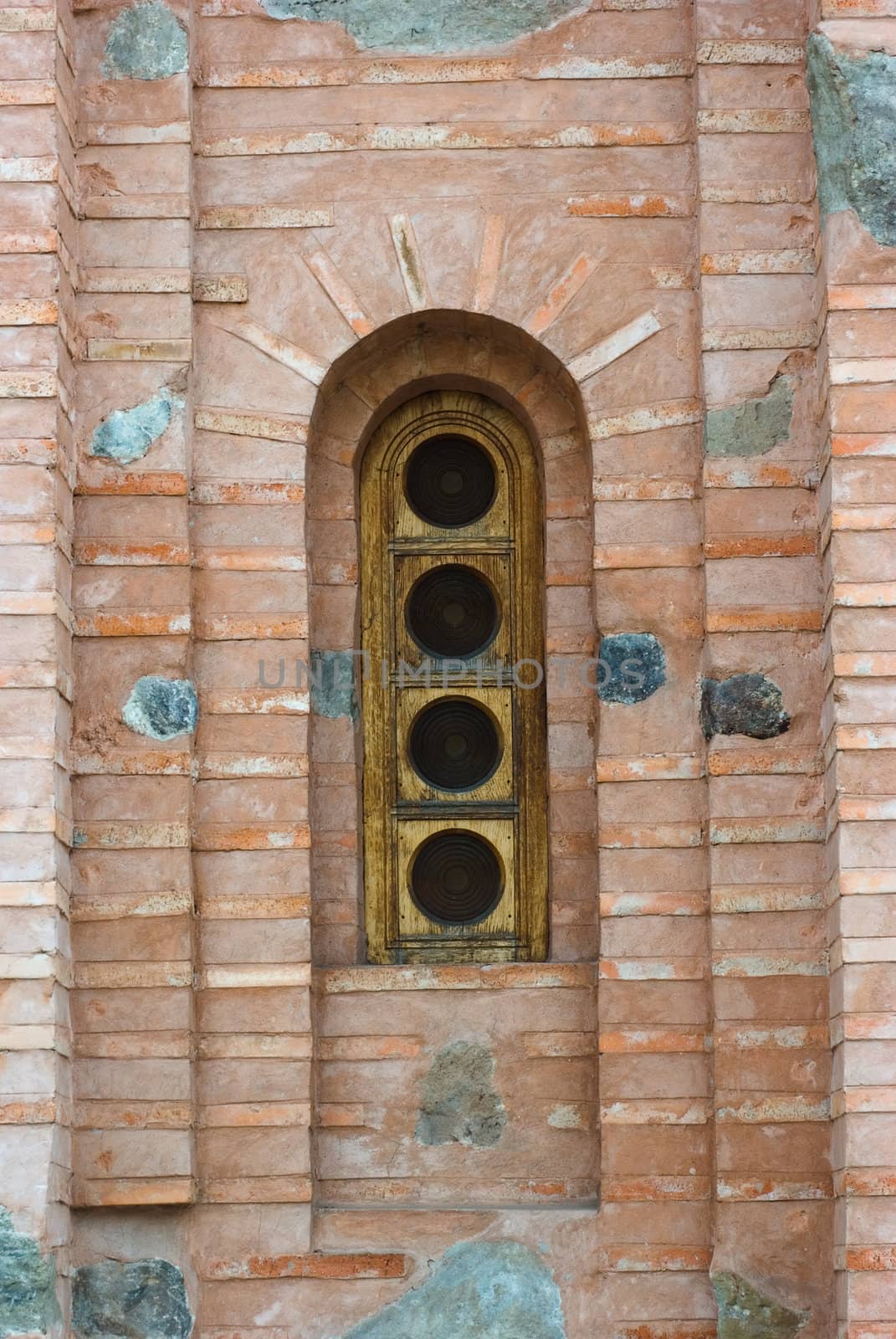 Arc shaped window on a brick wall