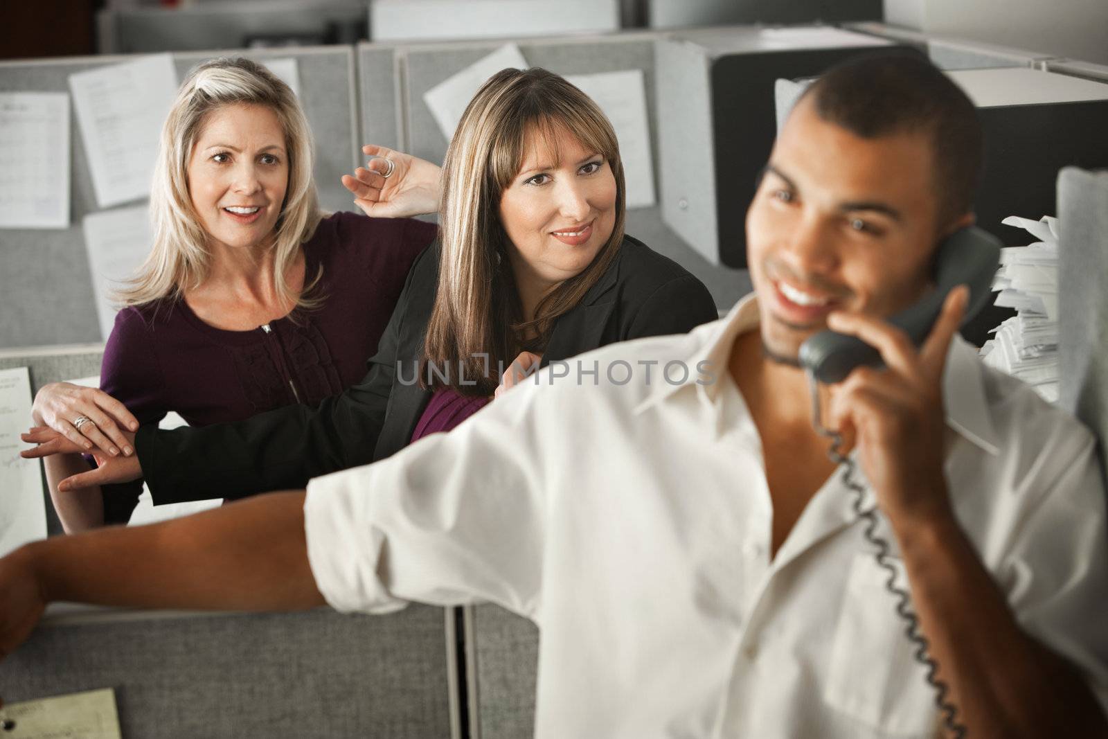 Women office workers flirt with handsome male coworker in office 