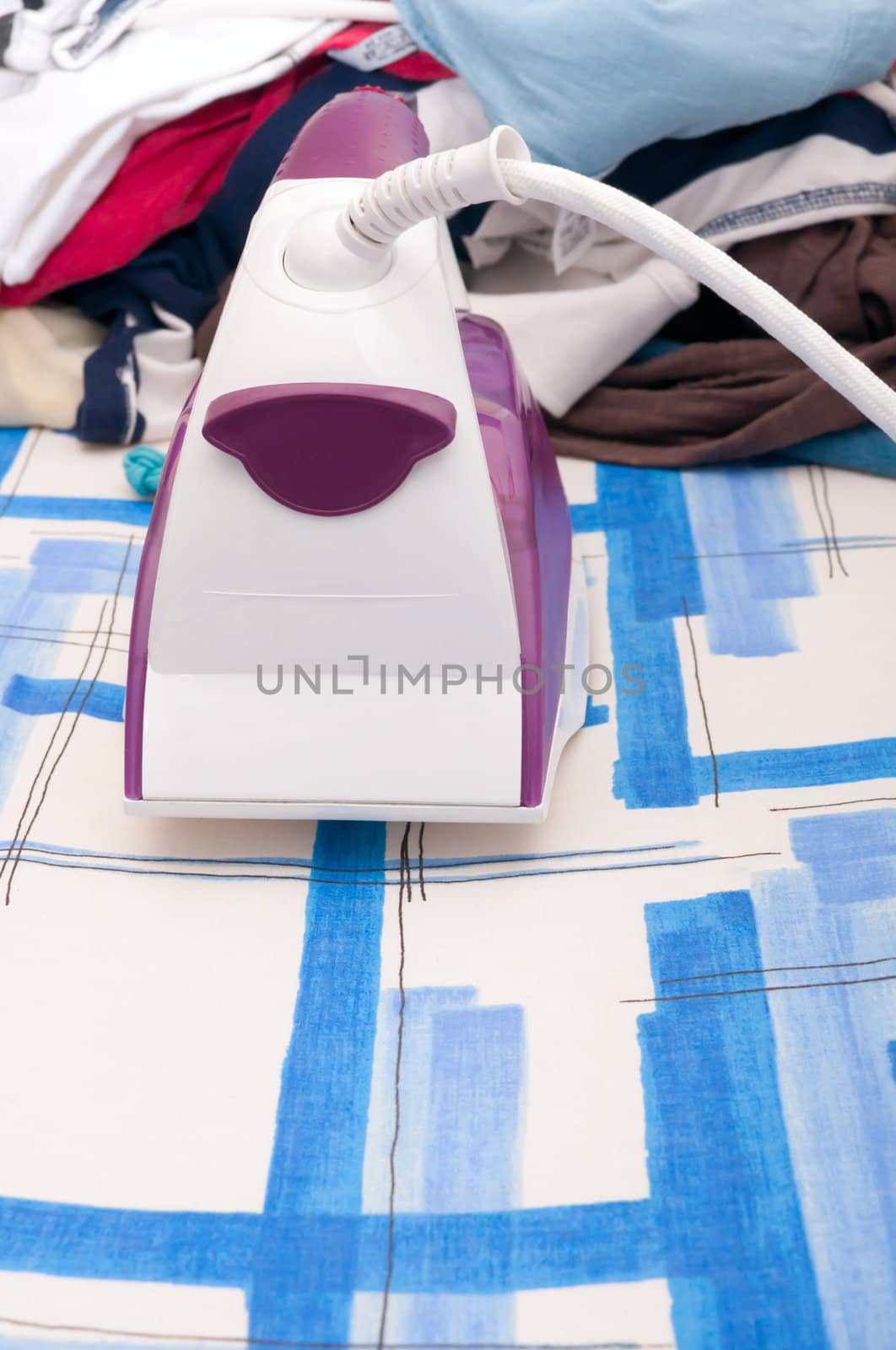 Ironing - Iron and Heap of Landry on Ironing Board