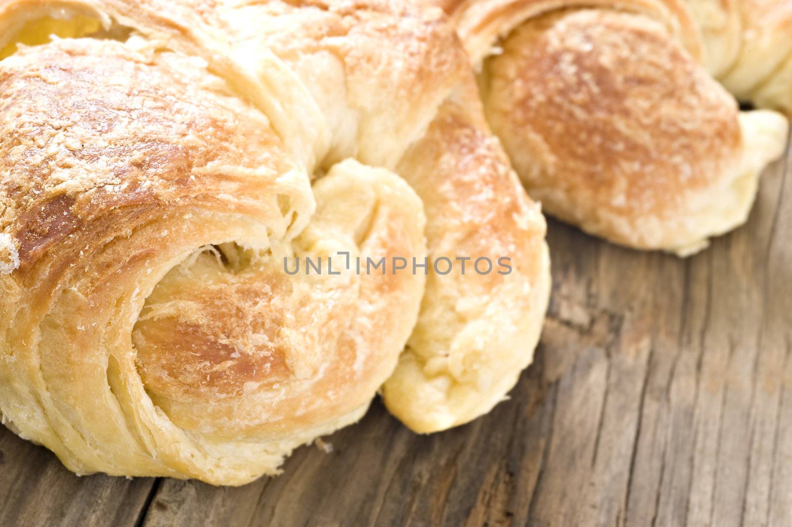 Close up of freshly baked croissants on a wooden surface