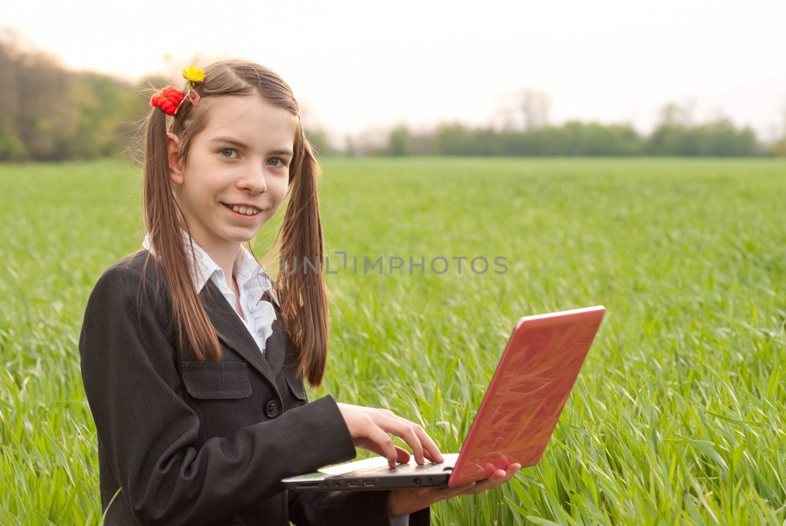 Teen girl with a notebook sitting outdoors