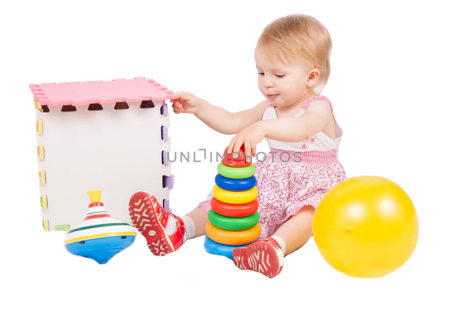 Baby girl playing toys over white