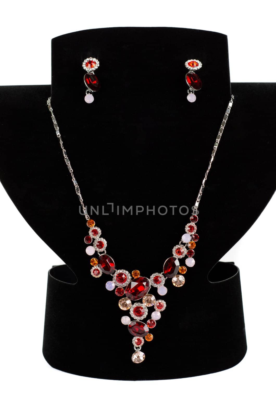 a necklace with pendants and earrings on a white background